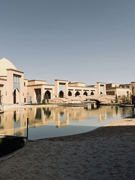 an elegant building is reflected in a pond