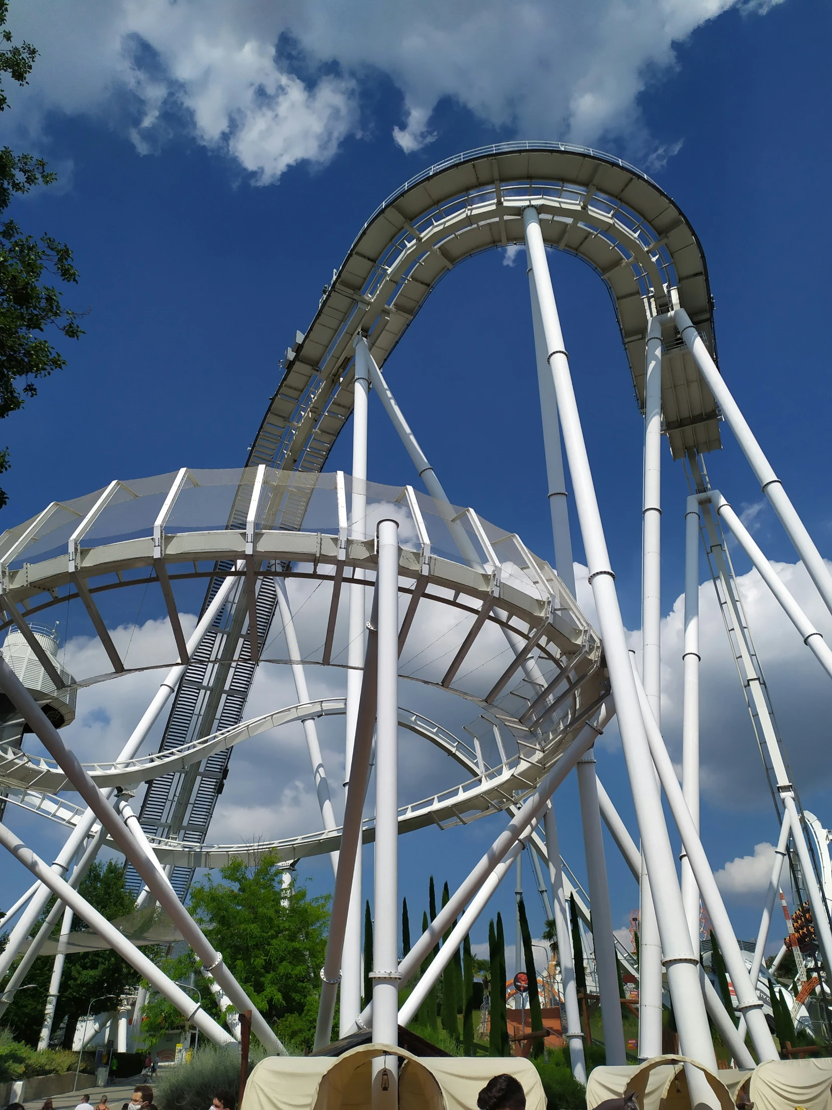 two chairs that are sitting in front of a roller coaster