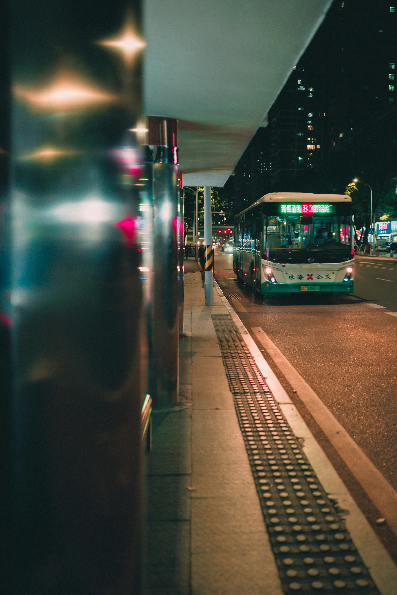 bus at a stop in an urban city at night