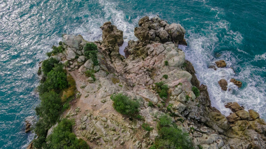 an aerial s of the rocky shore on a bright day