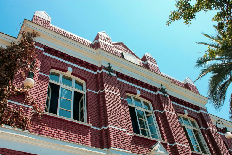 a red building with lots of windows and white trim