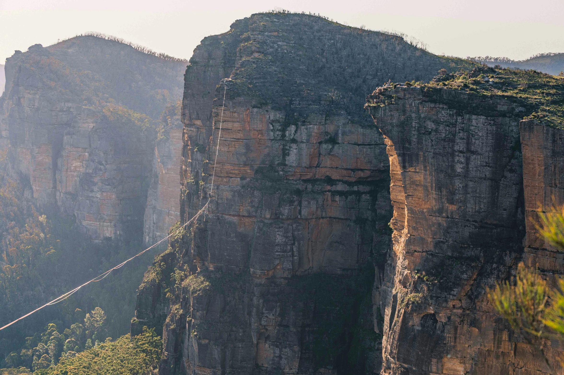 the landscape features a long rope over many rocky mountains