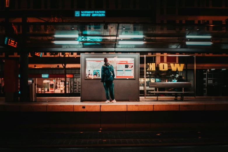 a person stands in front of a window at night