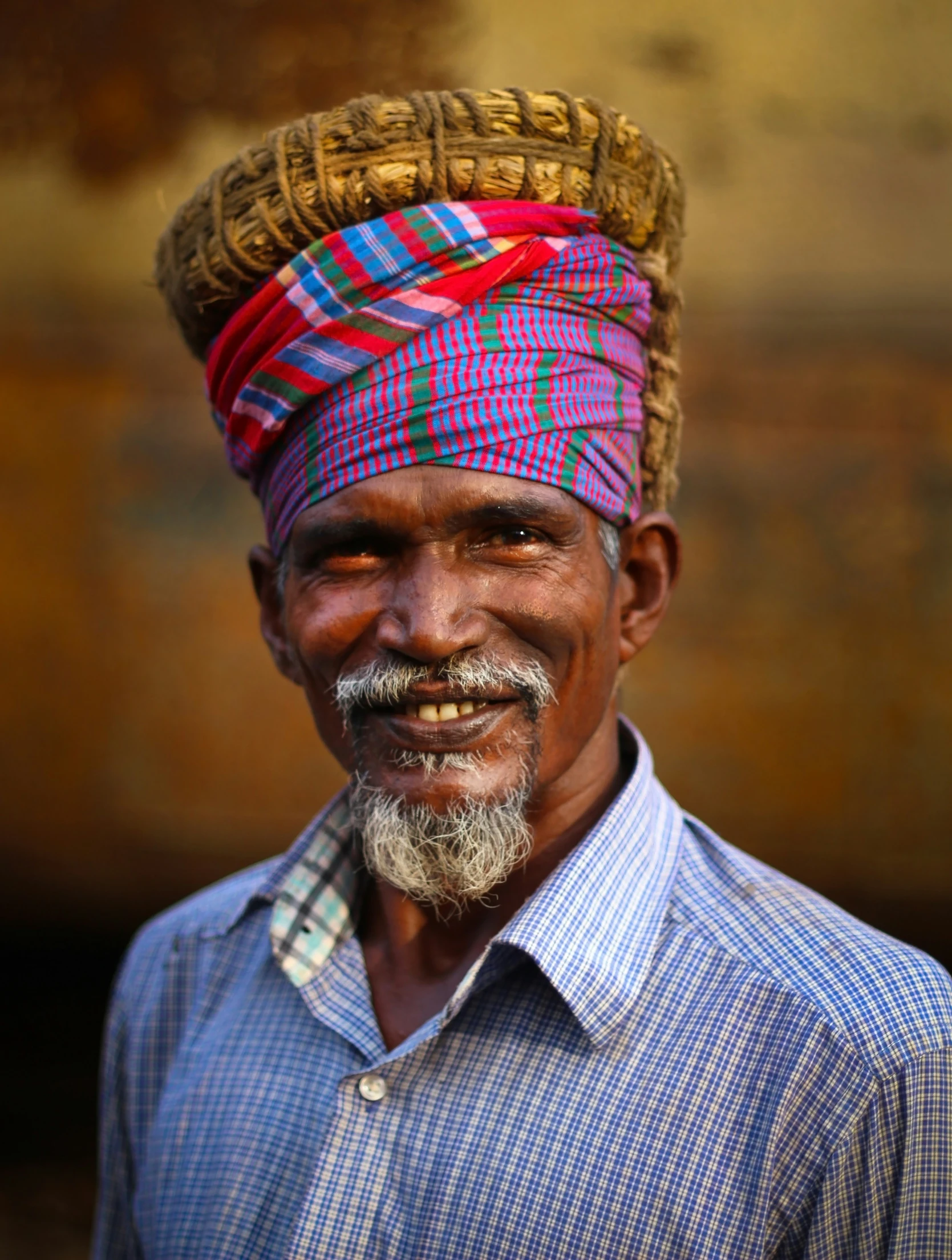 an old man with a hat on and a big smile