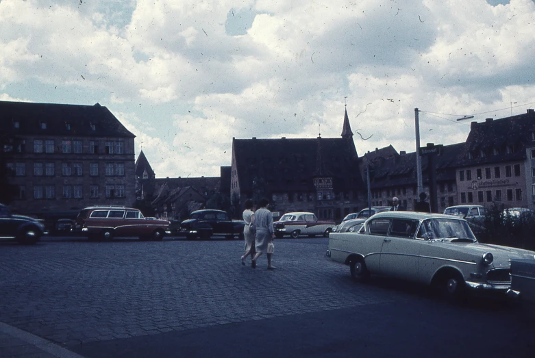 the older man walks towards an old style car