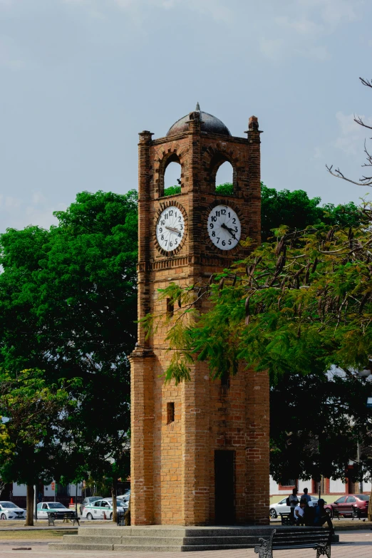 a big brick clock tower in the middle of town