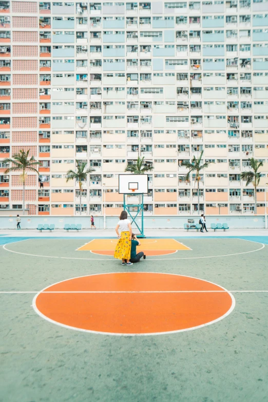 basketball court with a few people sitting in it