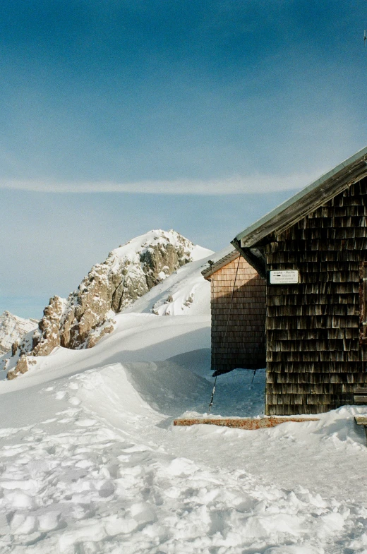 a cabin on a hill with snow in front of it