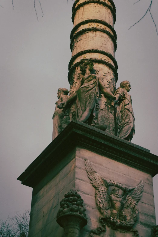 a tall building with statues on the top of it