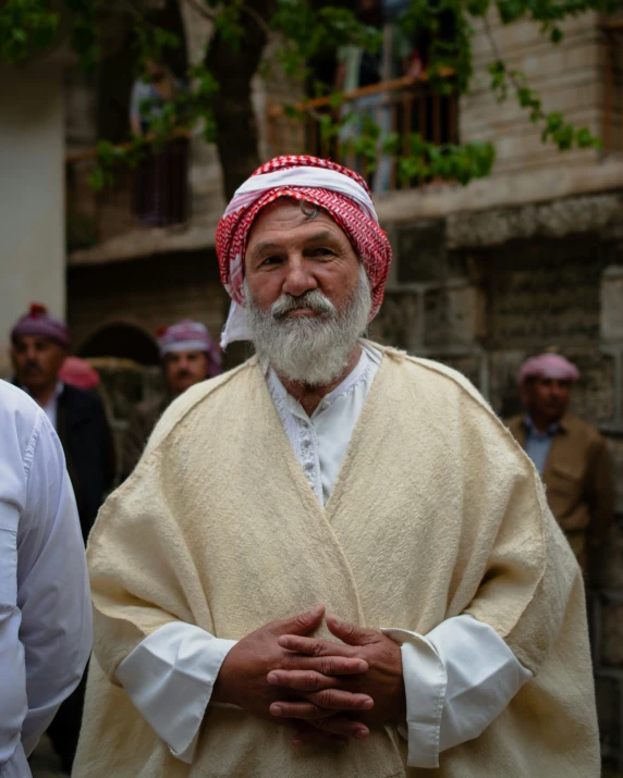 a man is dressed in an orange turban