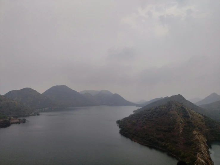 an airplane is flying over a large lake