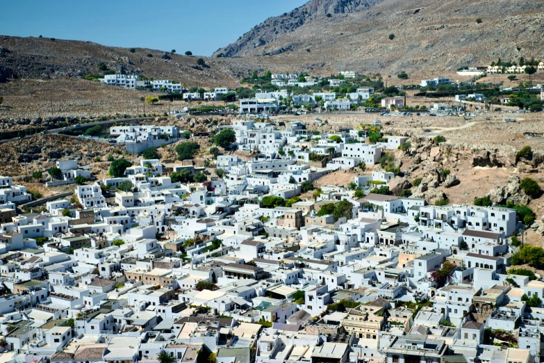 a white village nestled among mountains and hills