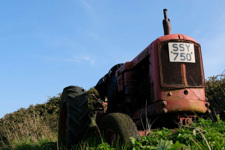 the back end of an abandoned tractor in a field