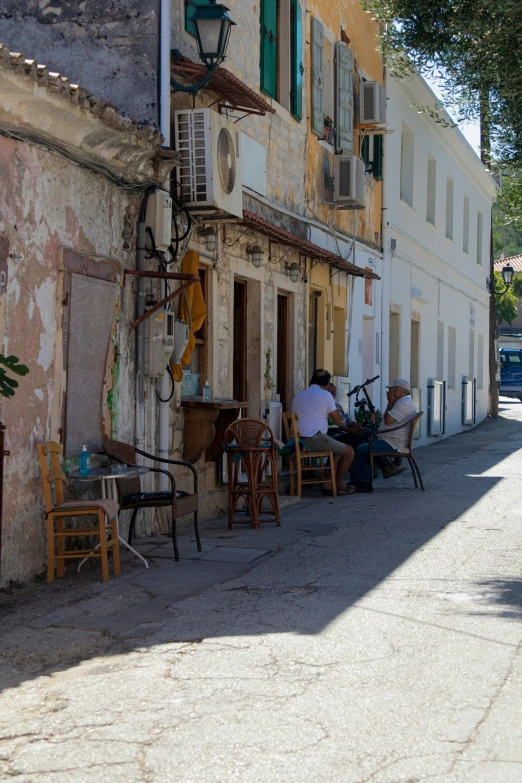 a group of people sit around an outdoor cafe