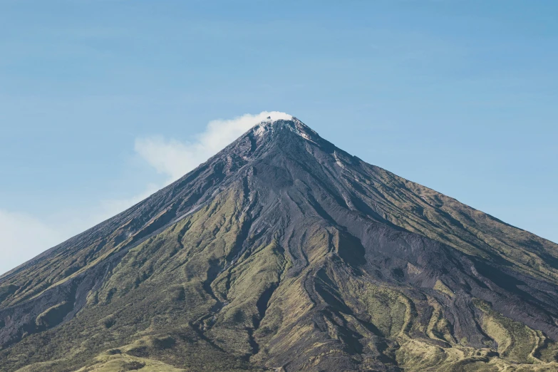 a mountain is seen near the water and mountains