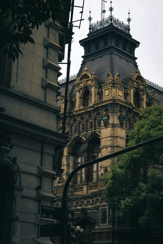 a very tall building with a clock and a weather vein