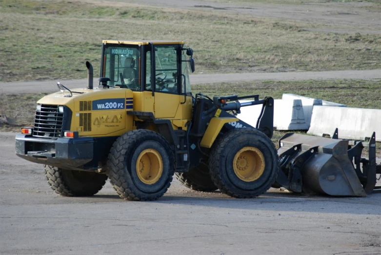 a wheel loader is sitting in the dirt