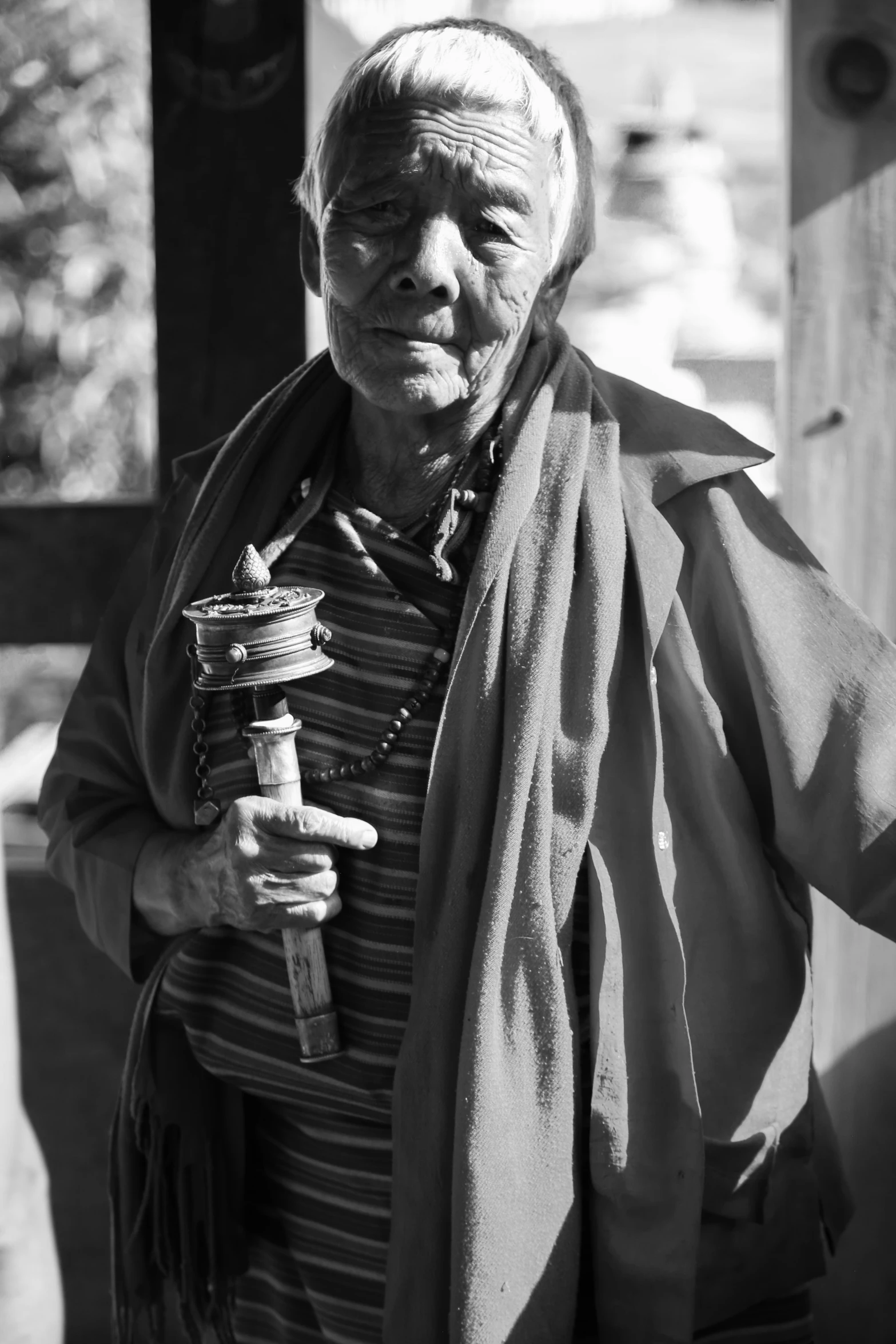 an older woman holding a wooden handled knife