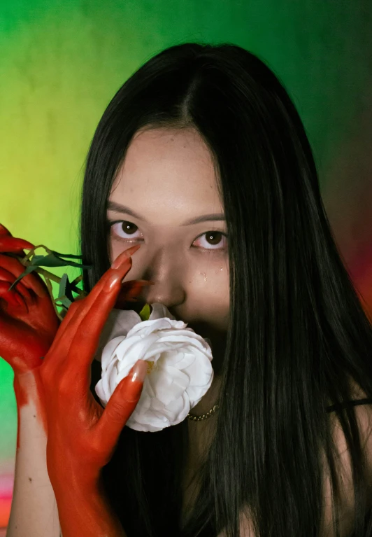 a lady covered in plastic gloves holding a dead rose