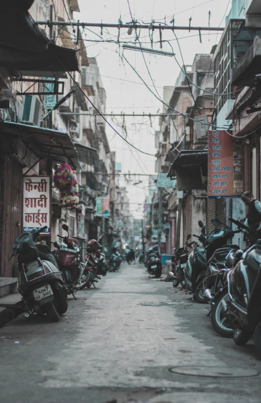 a row of motorcycles on a street side walk