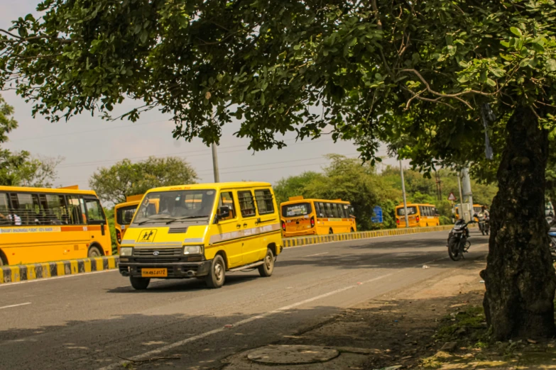 a bunch of buses parked in a lot with one bus