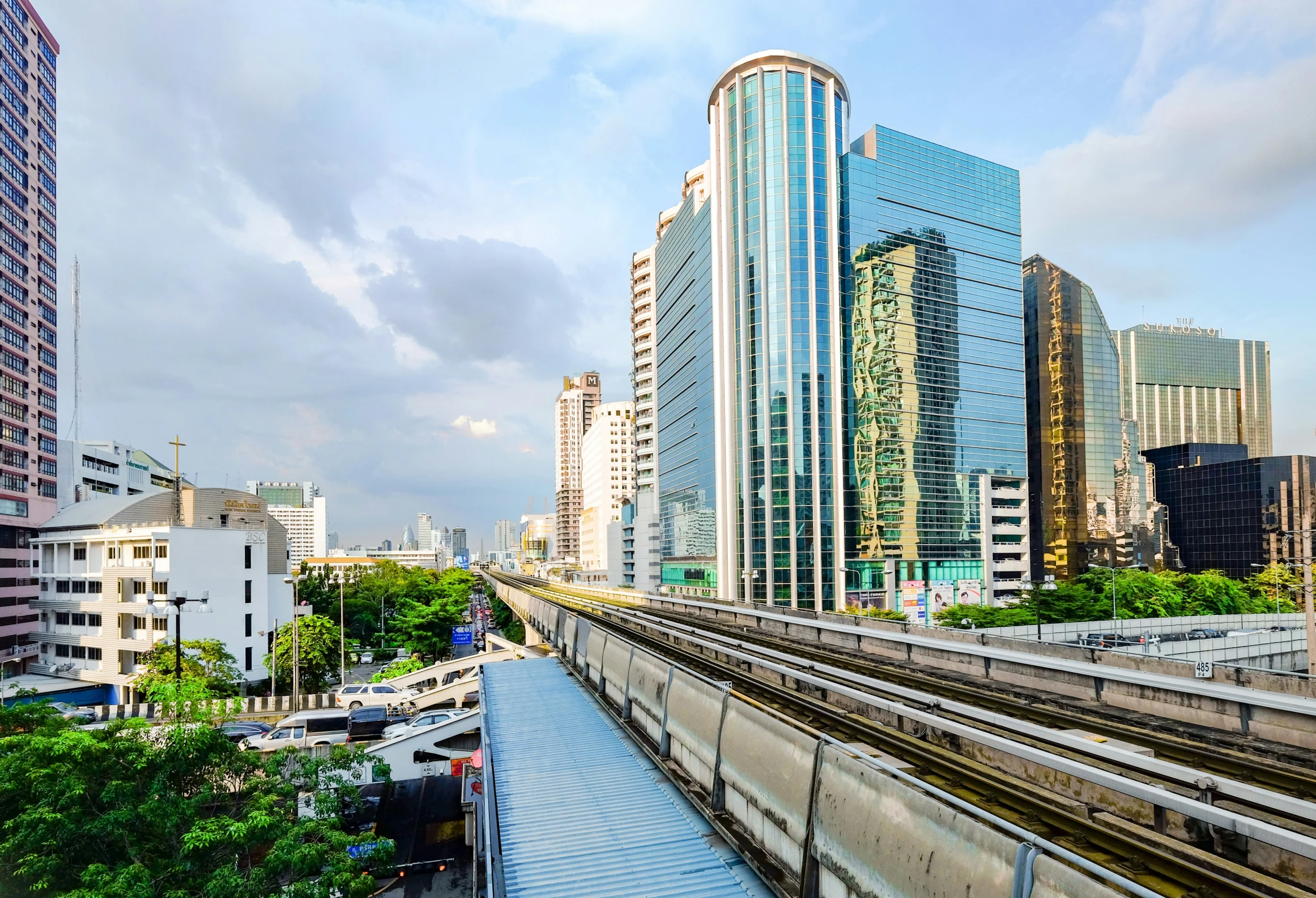 a view of a rail track and city skyline