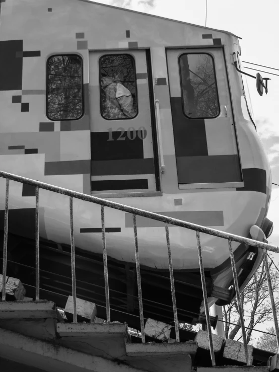 stairs leading to an unusual looking train parked in a depot