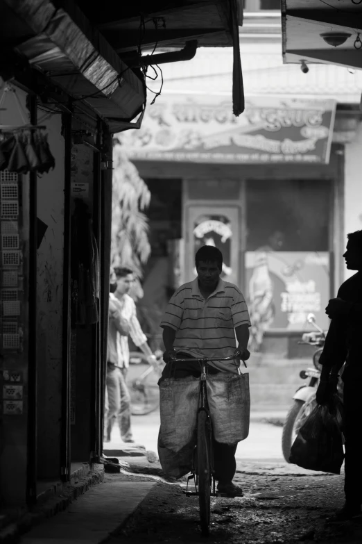 two people walking down a street on the sidewalk