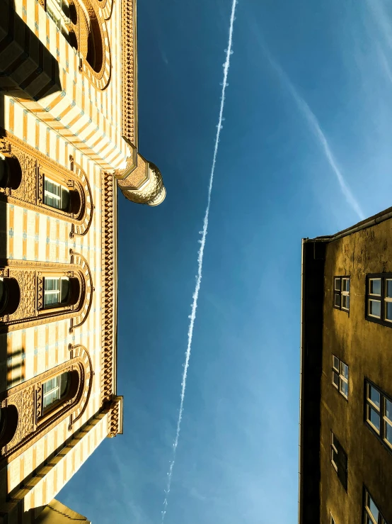 two buildings on the corner with a blue sky in the background