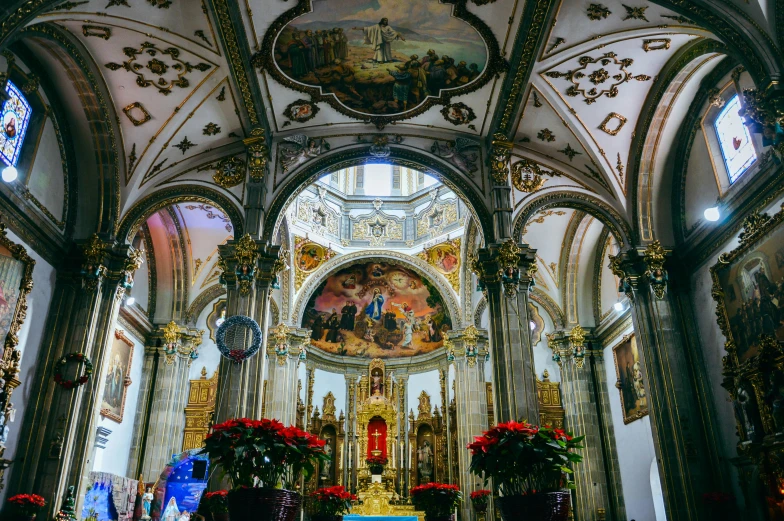 a church with a very large ornate white alter