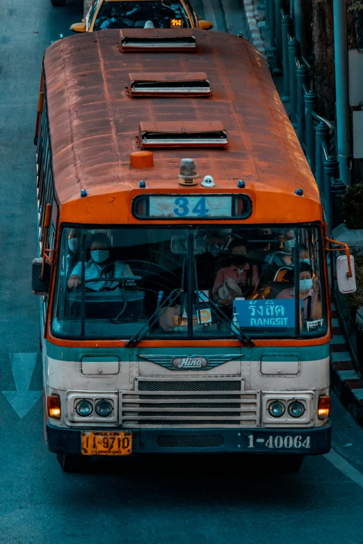 a bus driving down a busy road in the sun