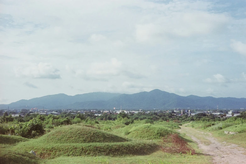 a big grassy hill by the road in the field