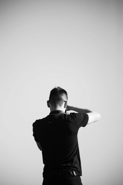 a black and white image of a man with his hair up