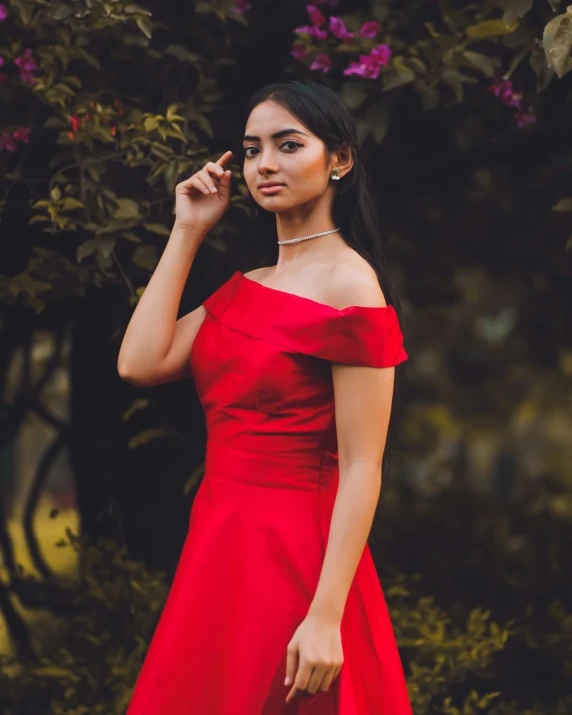 a woman in red is holding her finger on her lips