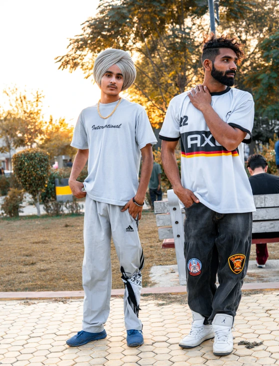 two guys who are standing in the park