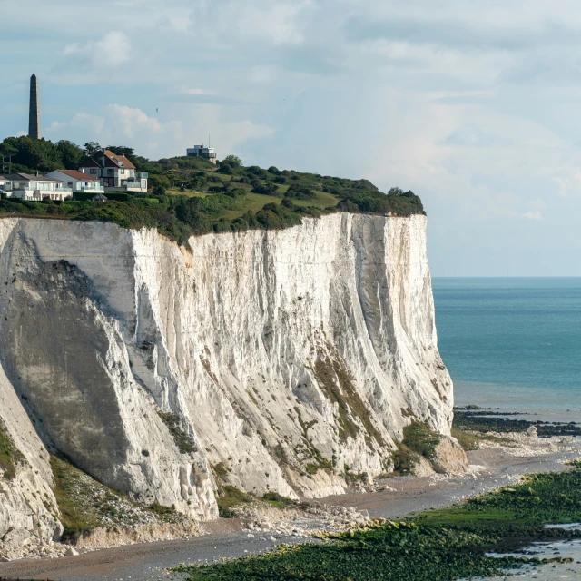 a large white cliff with houses on top