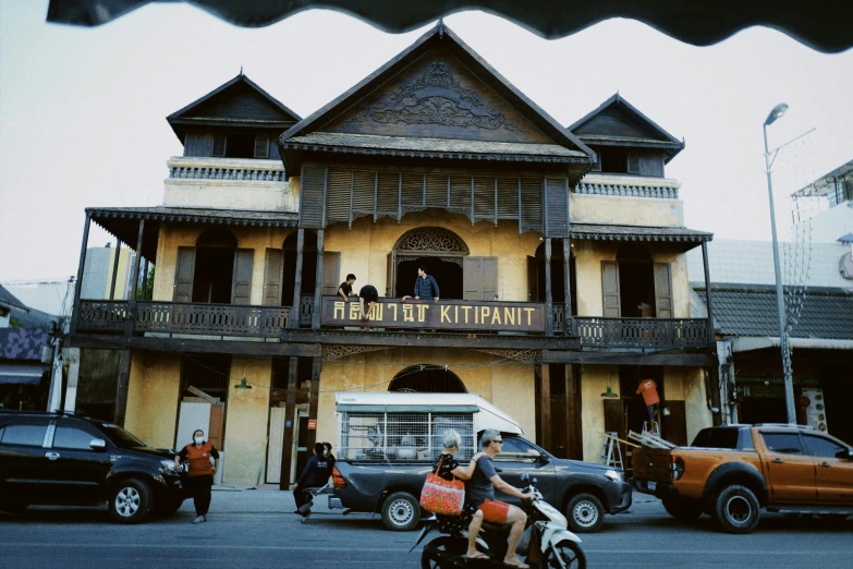 a person is riding a motorcycle in front of an old style building