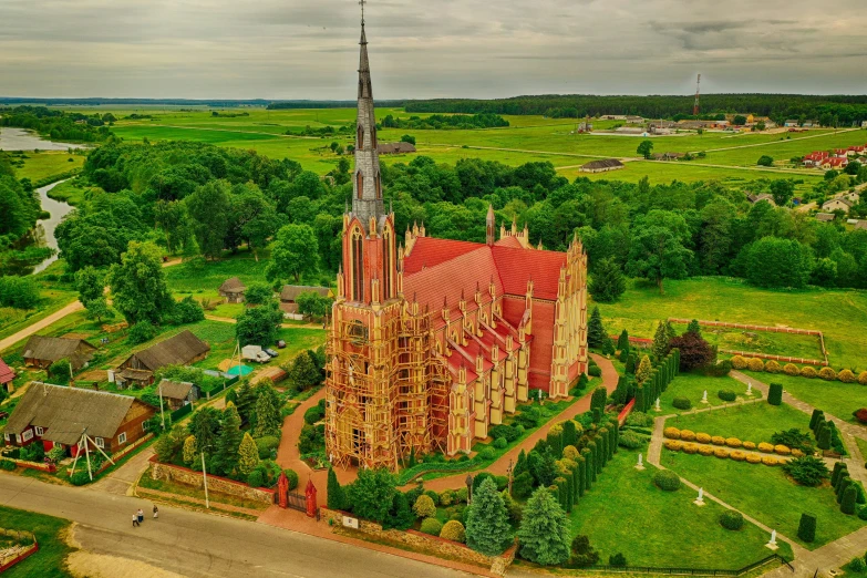 a very pretty red and gold church in the middle of nowhere