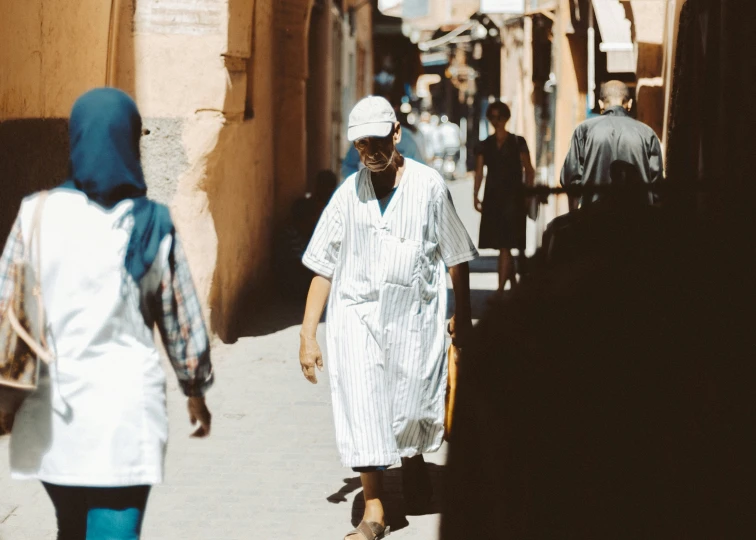 several people are walking along a street