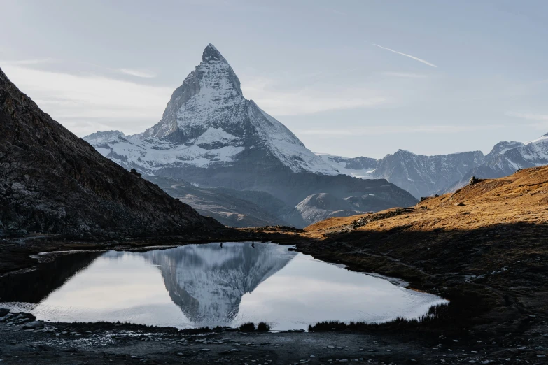 the mountains rise above the lake below