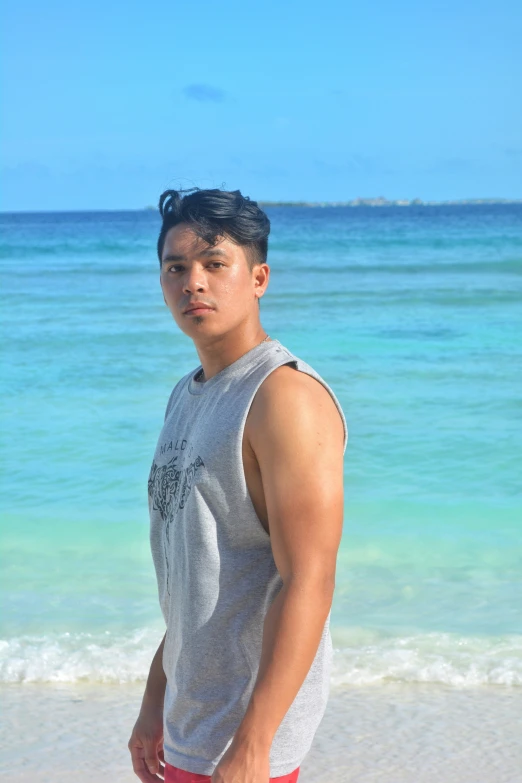 man standing at the beach looking into camera