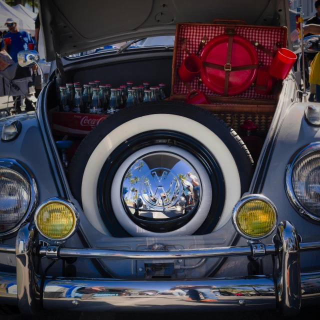 the trunk of a car has several items piled on top of it