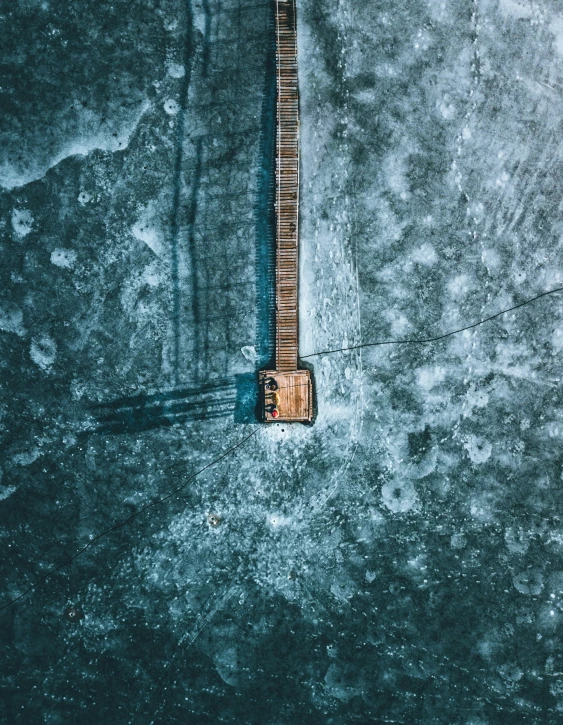 a wooden object is floating in a large body of water