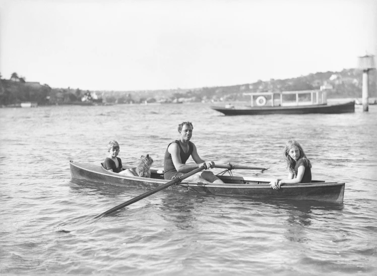 a man and two children in a row boat