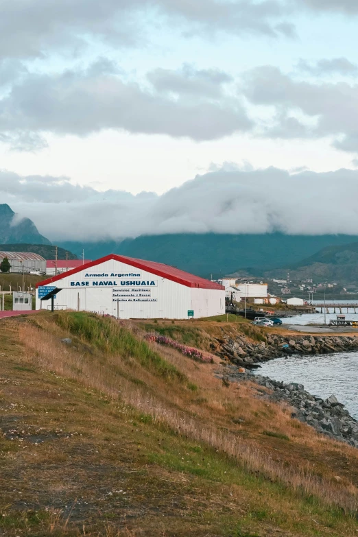 the ocean and the hill are near a white building