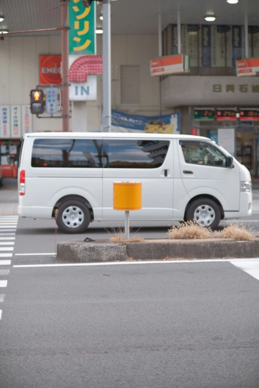 a white van is parked at a curb
