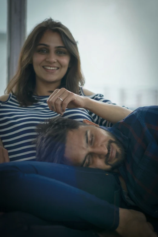 woman smiling next to man laying on his back