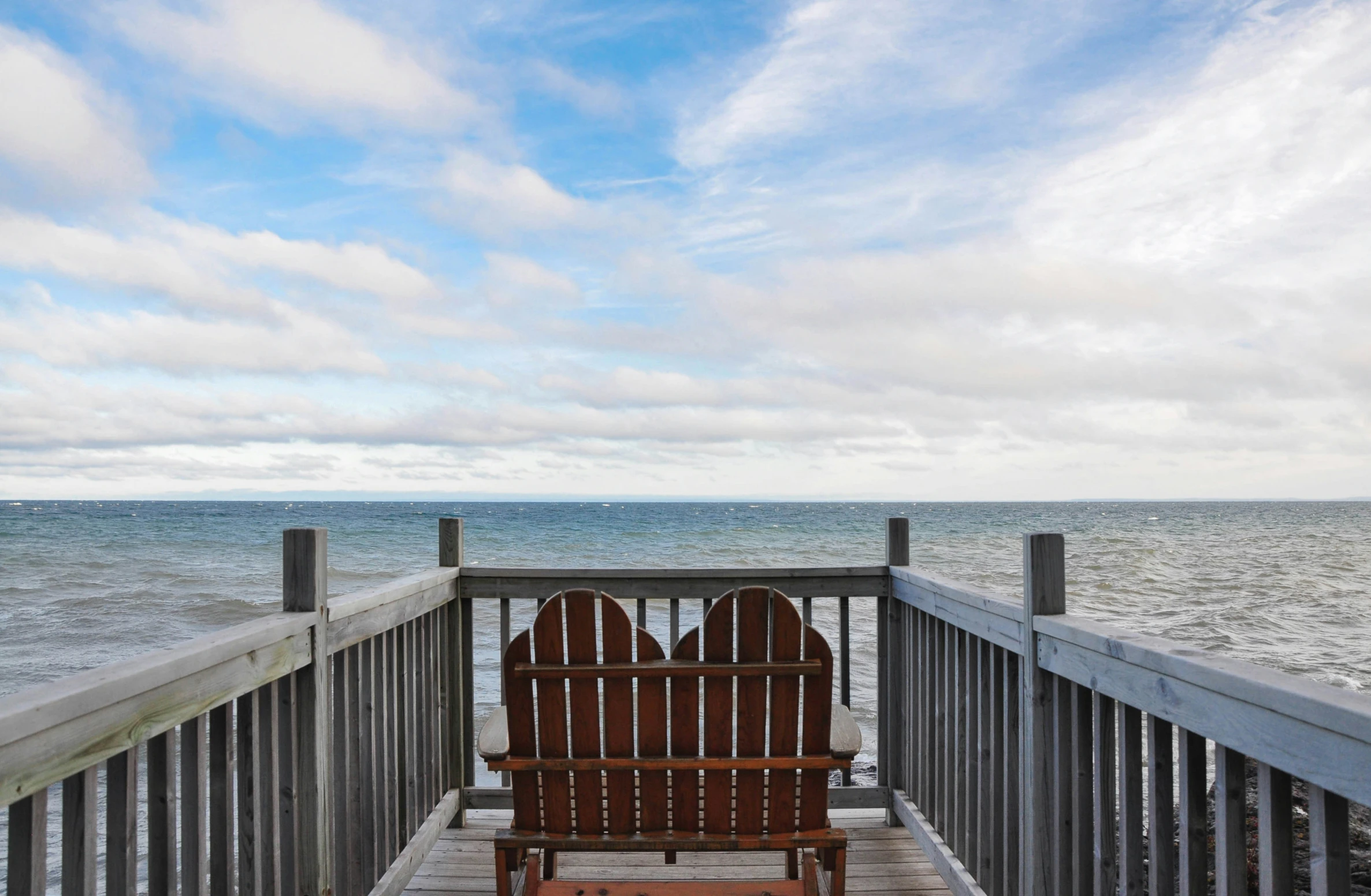 a wooden bench sitting on top of a wooden boardwalk