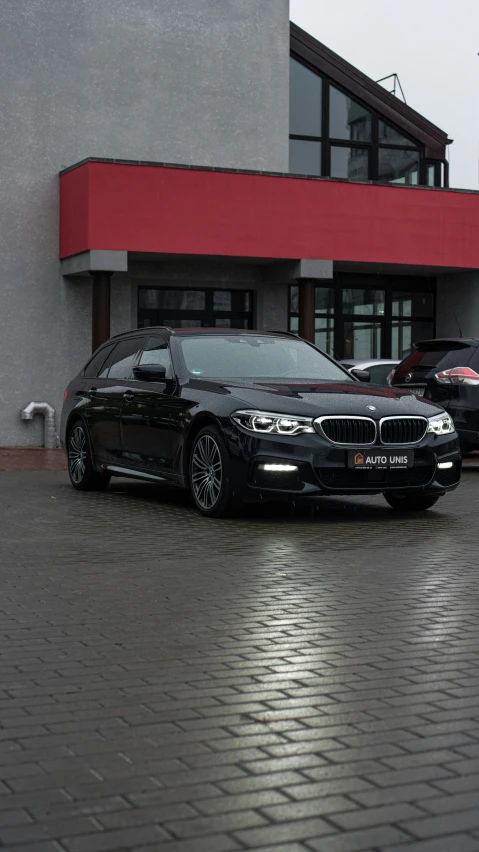 there is a black bmw parked outside of the business