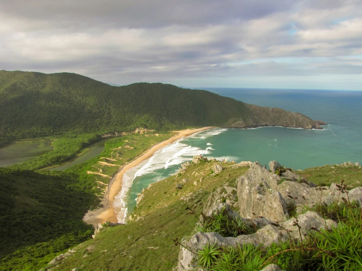 the view of an island and beach from top of a hill